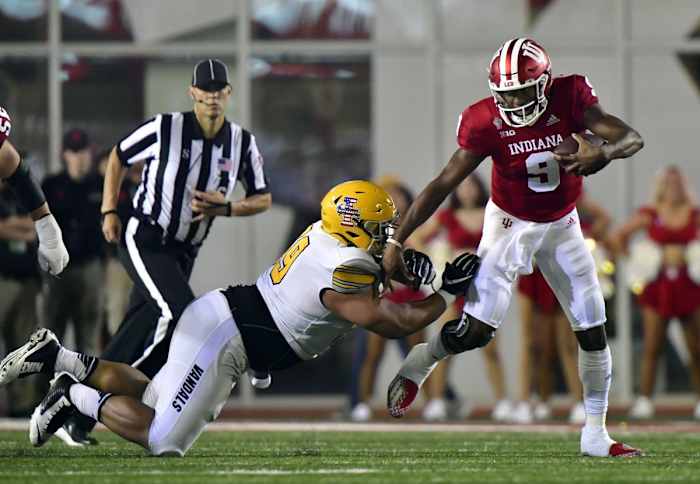 Indiana quarterback Michael Penix Jr. (9) evades a tackle against Idaho defensive lineman Noah Elliss (99). Mandatory Credit: Marc Lebryk-USA TODAY Sports